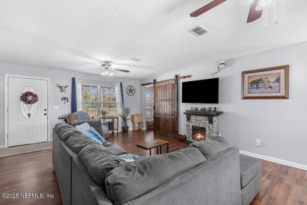 54170 Church Road Callahan, FL 32011 - Photo 11 of 44 a living room with furniture and a flat screen tv