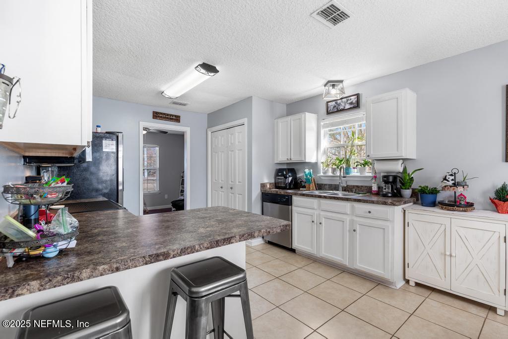 54170 Church Road Callahan, FL 32011 - Photo 21 of 44 a kitchen with granite countertop white cabinets and chairs