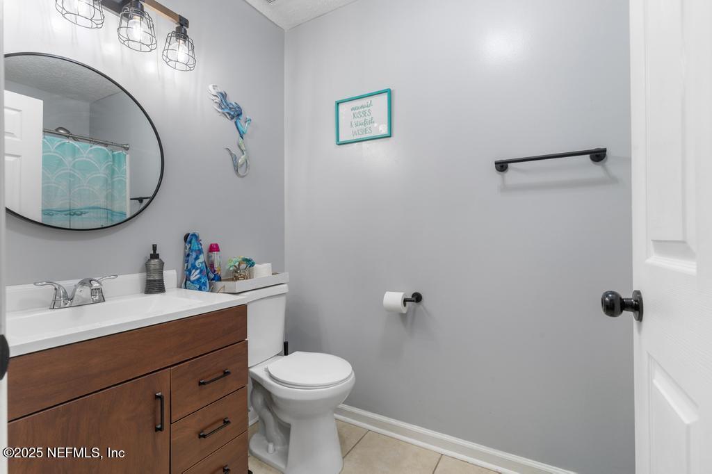 54170 Church Road Callahan, FL 32011 - Photo 25 of 44 a bathroom with a toilet a sink and mirror
