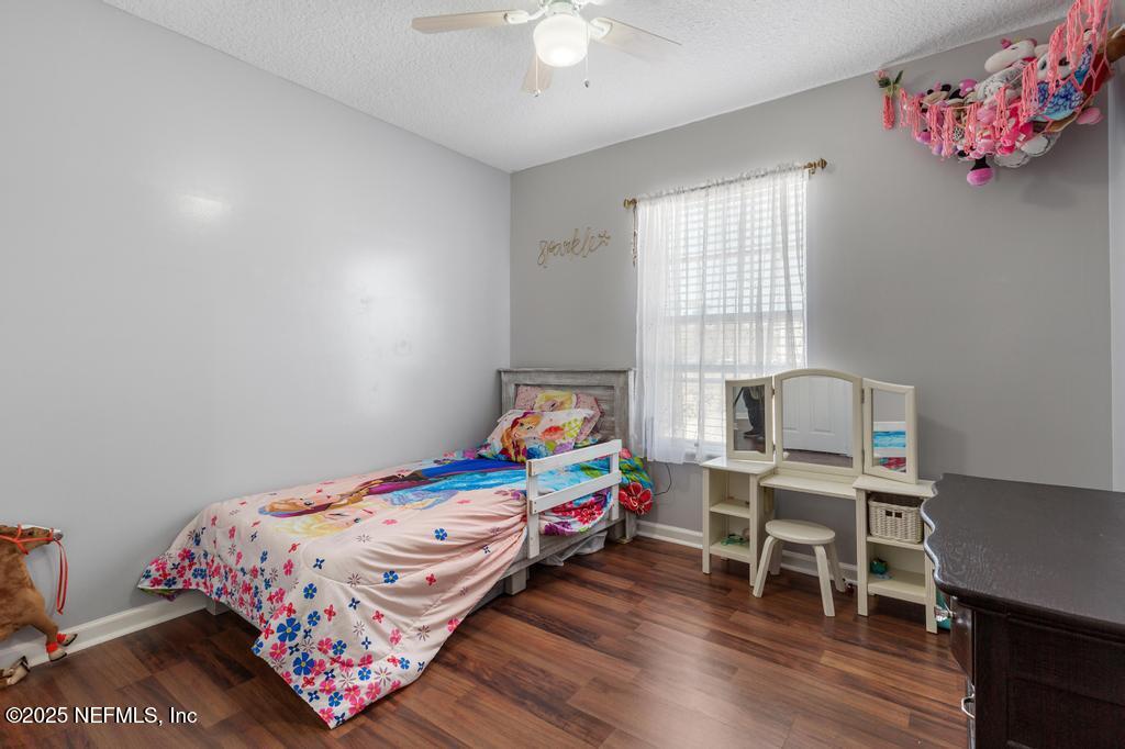 54170 Church Road Callahan, FL 32011 - Photo 27 of 44 a bedroom with a bed and a desk in it