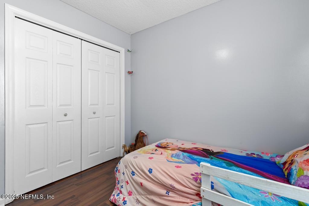54170 Church Road Callahan, FL 32011 - Photo 28 of 44 a room with a bed and wooden floor