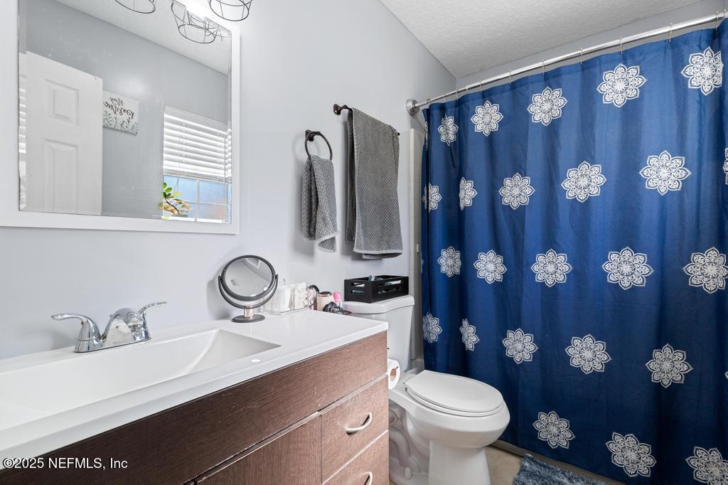 54170 Church Road Callahan, FL 32011 - Photo 33 of 44 a bathroom with a sink vanity mirror and toilet