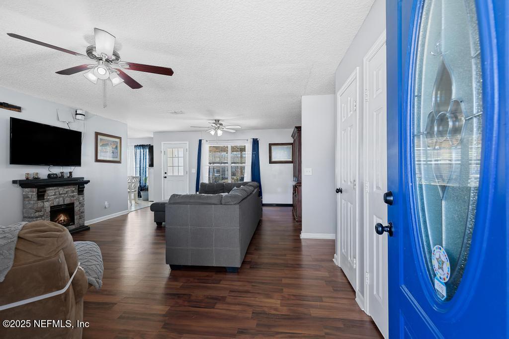 54170 Church Road Callahan, FL 32011 - Photo 7 of 44 a living room with furniture a flat screen tv and a window