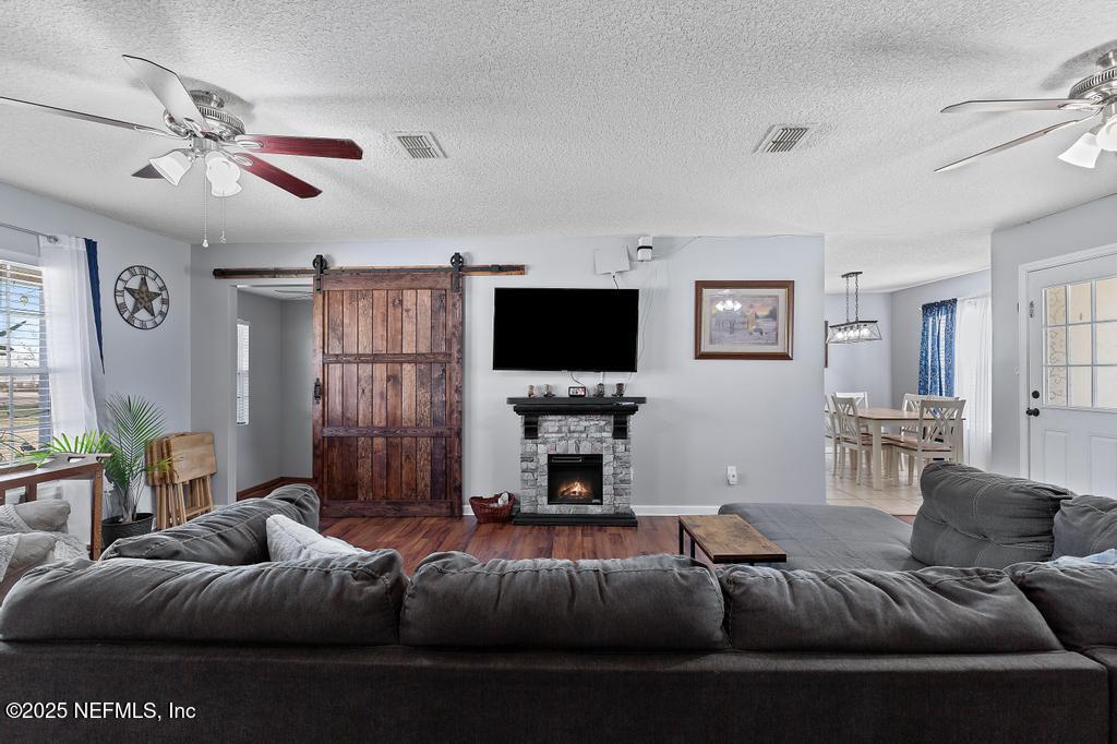 54170 Church Road Callahan, FL 32011 - Photo 10 of 44 a living room with furniture and a flat screen tv