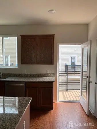 a kitchen with stainless steel appliances granite countertop a sink and a stove top oven