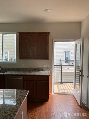 a kitchen with stainless steel appliances granite countertop a sink and a stove top oven