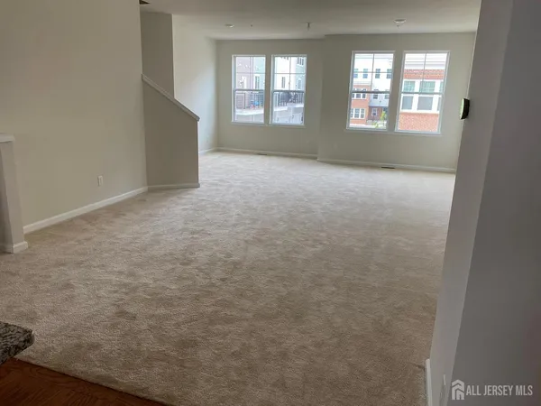 a view of an empty room with two windows