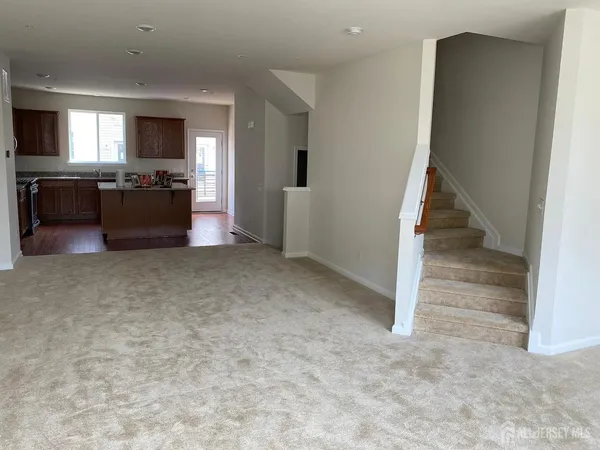 an empty room with a kitchen and a sink