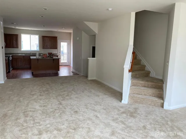an empty room with a kitchen and a sink