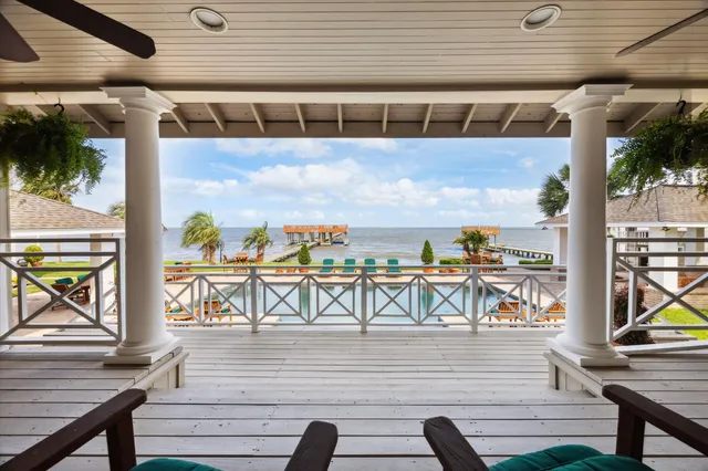 a view of a house with a yard patio and tree