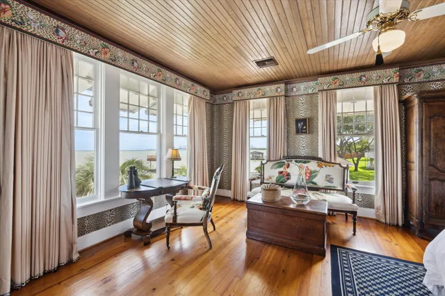 a living room with furniture a table and a large window