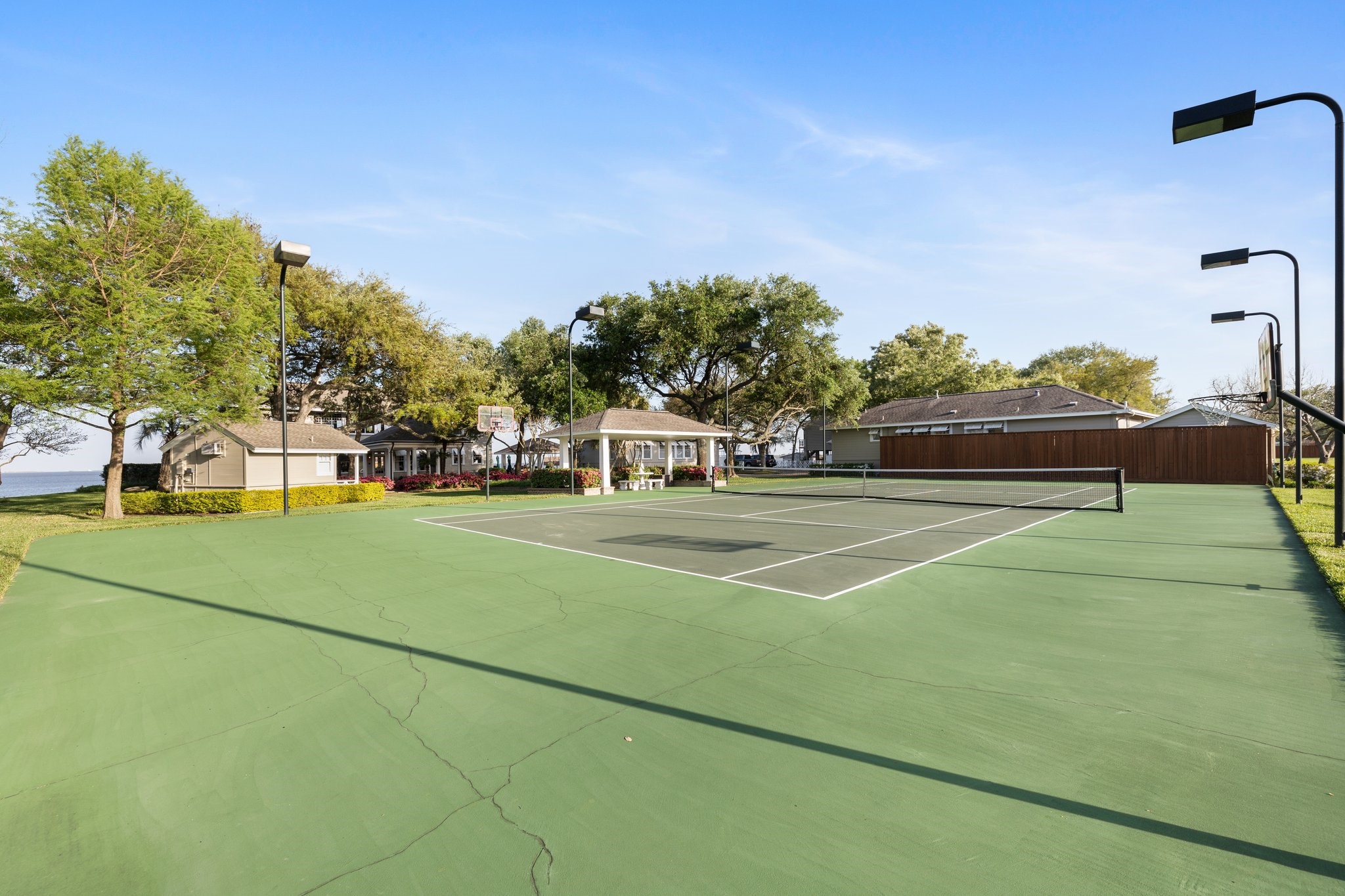 102 South R Street La Porte, TX 77571 - Photo 41 of 43 a view of a tennis ground with large trees