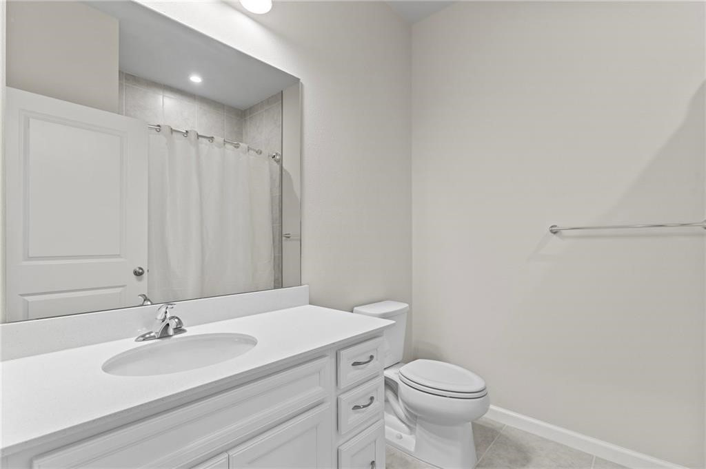 6710 Rumine Circle Vero Beach, FL 32967 - Photo 13 of 28 a bathroom with a sink a toilet and a mirror