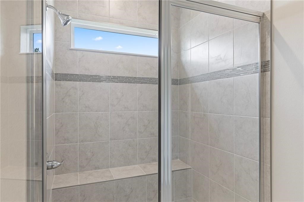 6710 Rumine Circle Vero Beach, FL 32967 - Photo 14 of 28 a bathroom with a glass shower door