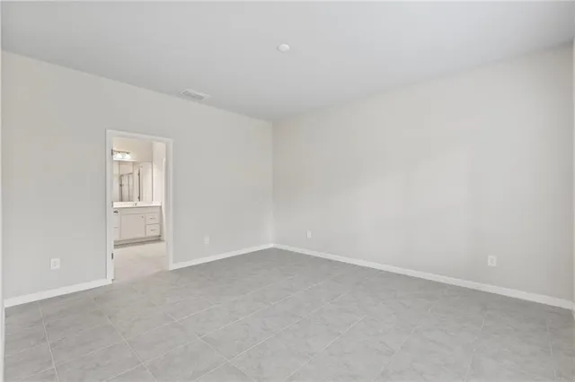 a view of an empty room with kitchen appliances and a window