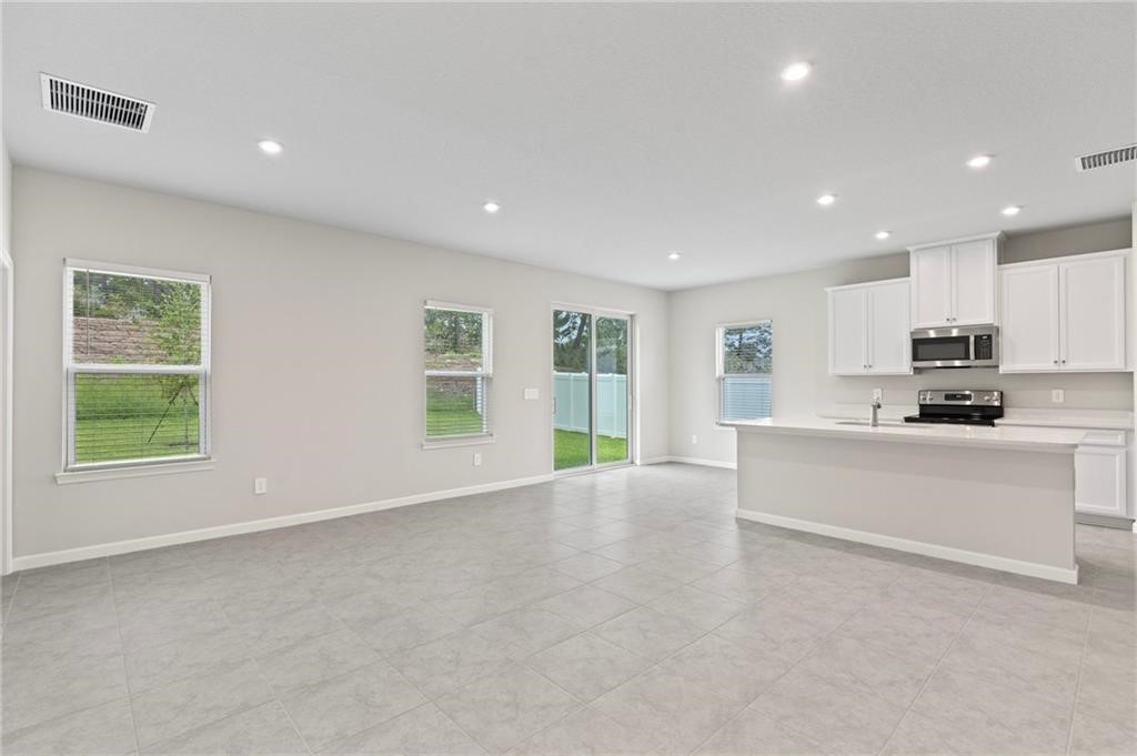 6710 Rumine Circle Vero Beach, FL 32967 - Photo 19 of 28 a view of an empty room with kitchen appliances and a window