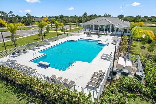 an aerial view of a house with swimming pool patio and outdoor seating