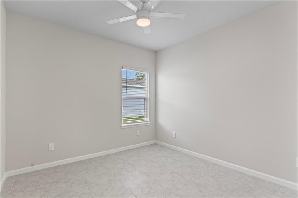 6710 Rumine Circle Vero Beach, FL 32967 - Photo 21 of 28 an empty room with a fan & a window