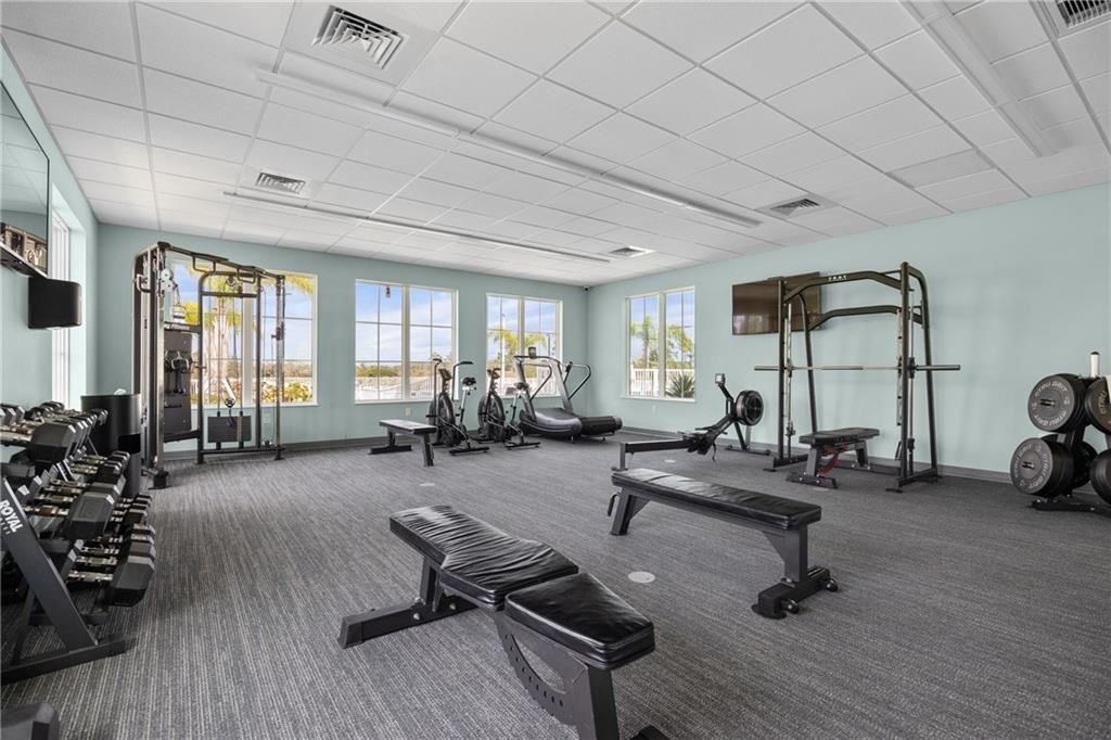 6710 Rumine Circle Vero Beach, FL 32967 - Photo 10 of 28 a living room with furniture gym equipment and a large window