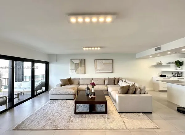 a living room with furniture and a large window