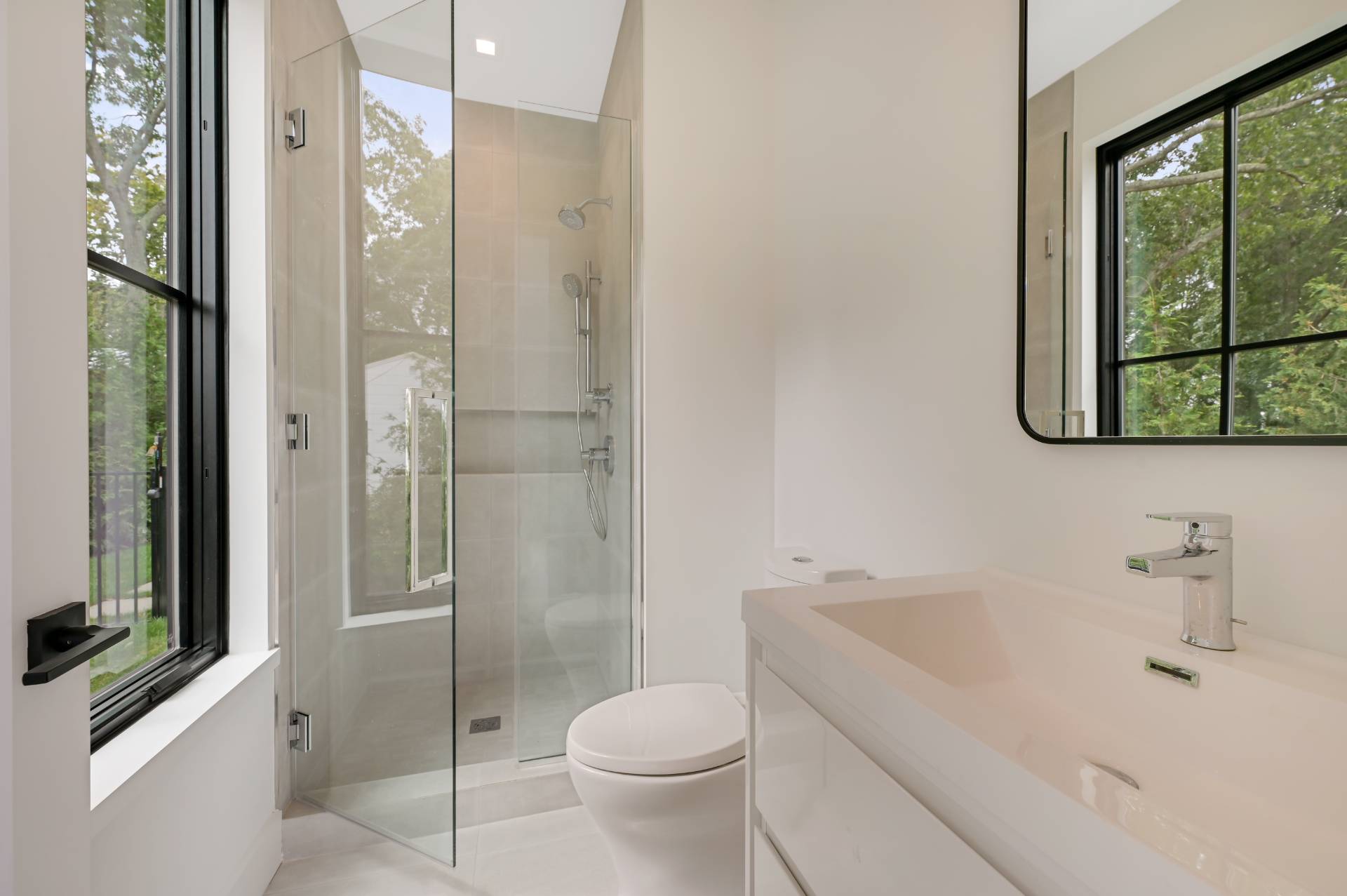 69 Ridge Drive Sag Harbor, NY 11963 - Photo 20 of 35 a bathroom with a toilet sink vanity and shower