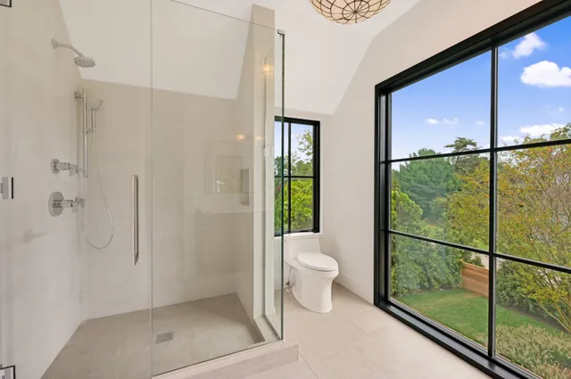 a bathroom with a window sink and mirror