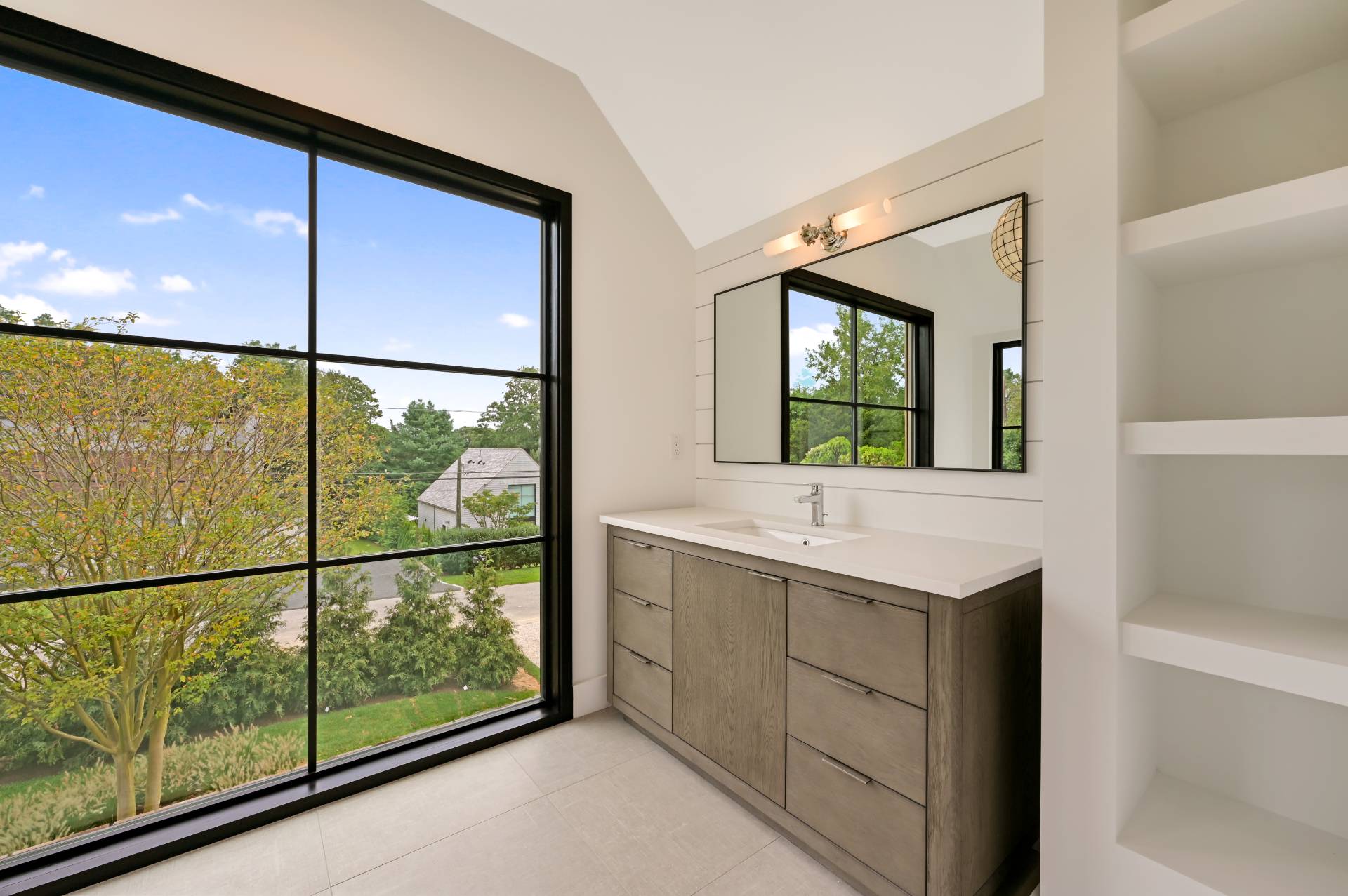 69 Ridge Drive Sag Harbor, NY 11963 - Photo 28 of 35 a bathroom with a window sink and mirror