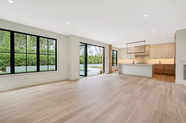 a view of kitchen with wooden floor and electronic appliances