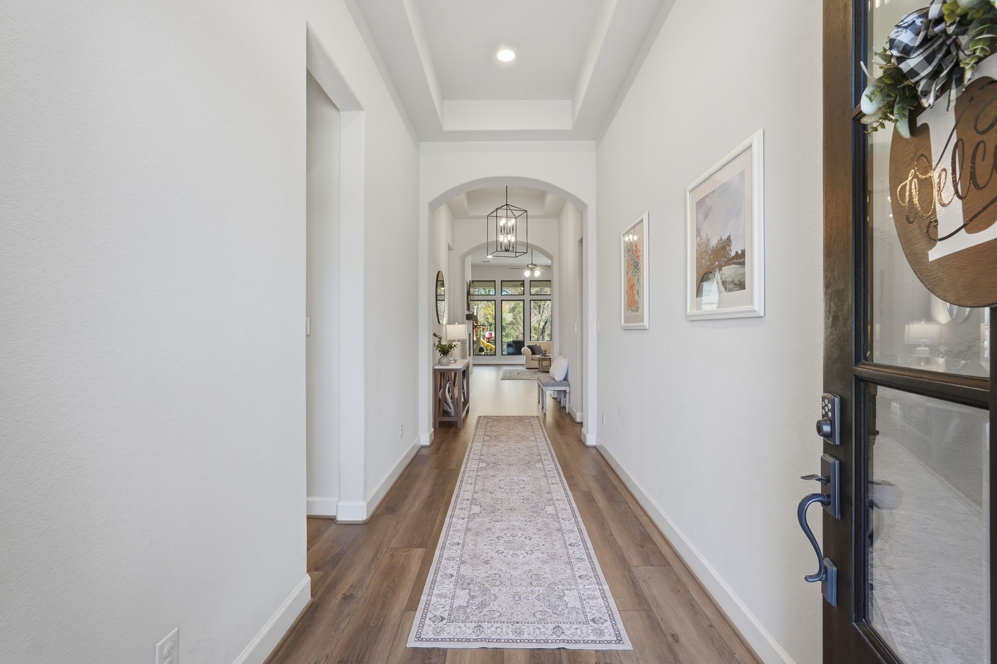 8602 Burdekin Road Magnolia, TX 77354 - Photo 6 of 50 This photo showcases an inviting entryway with a long hallway featuring LVP Flooring