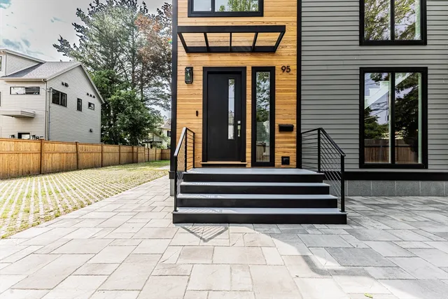 a backyard of a house with barbeque oven and outdoor seating