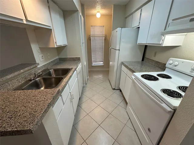 a kitchen that has a sink and a stove