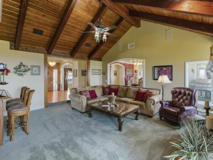 a dining room with furniture potted plants and wooden floor