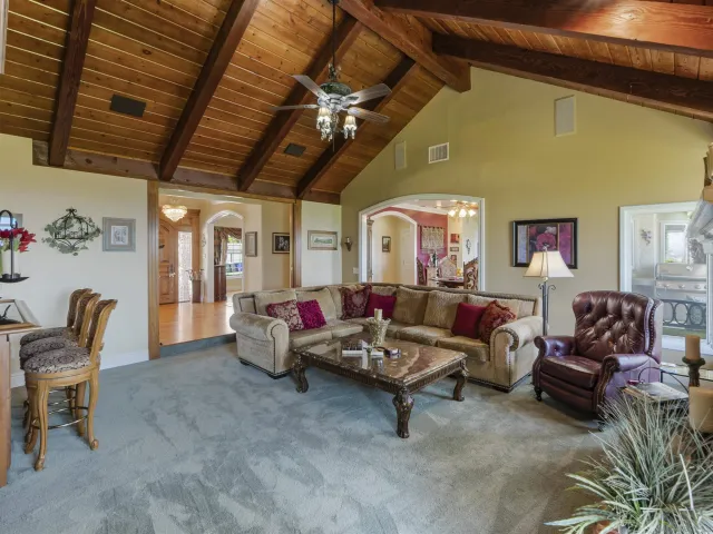 a dining room with furniture potted plants and wooden floor