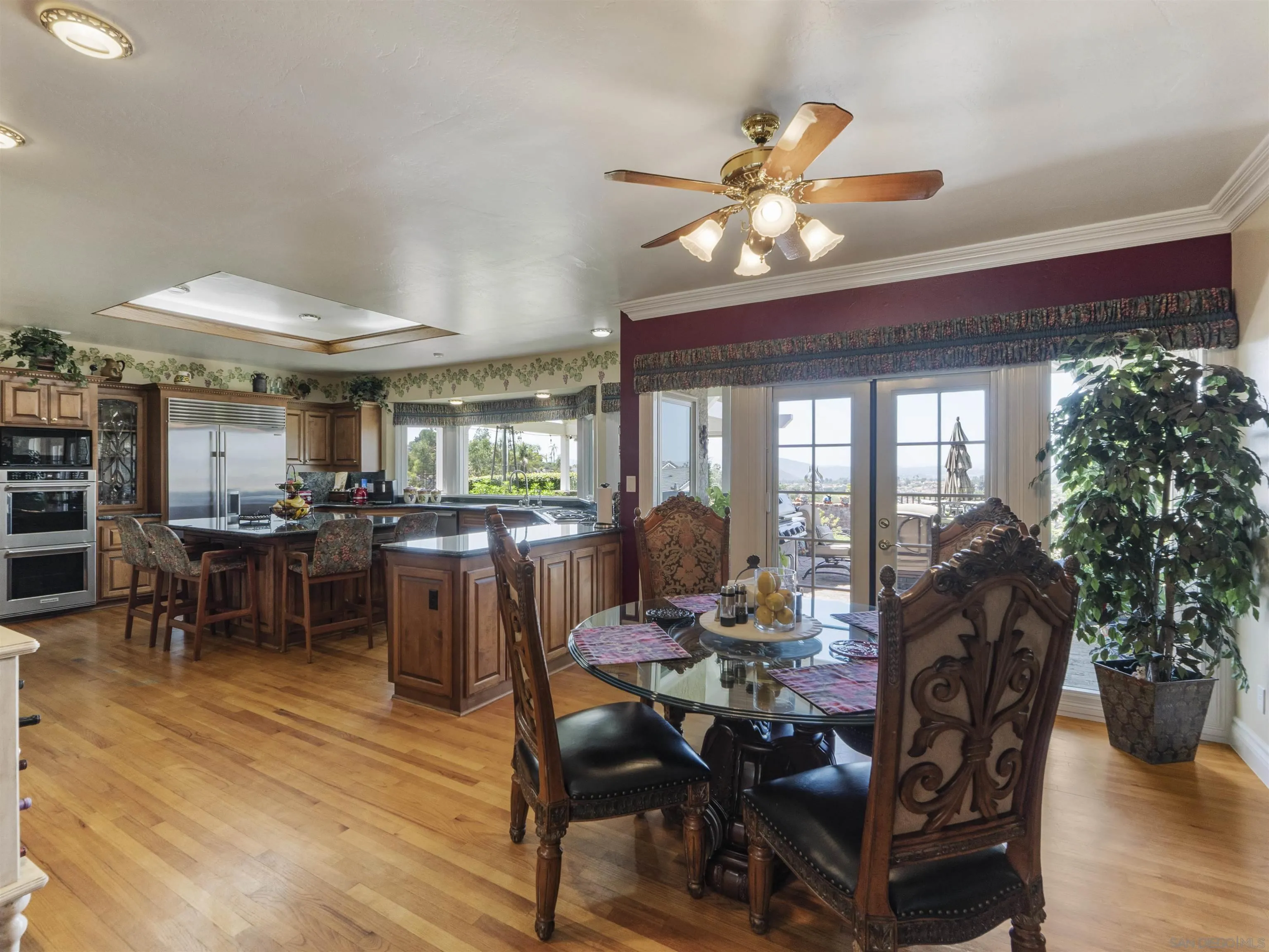17502 Corte Lomas Verdes Poway, CA 92064 - Photo 14 of 69 a dining room with furniture potted plants and wooden floor