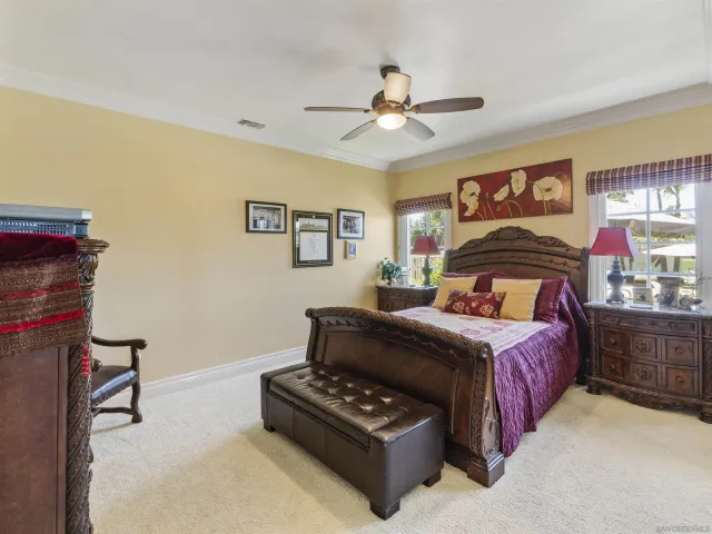 a bedroom with a bed dresser and a window