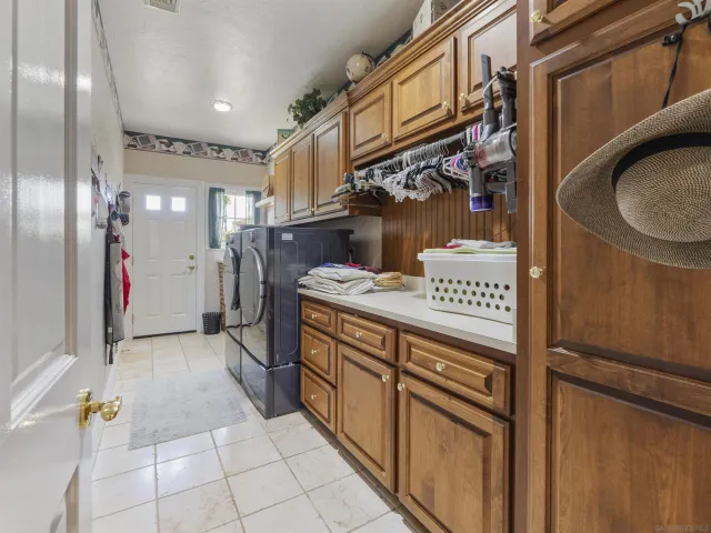 a view of a patio with table and chairs potted plants