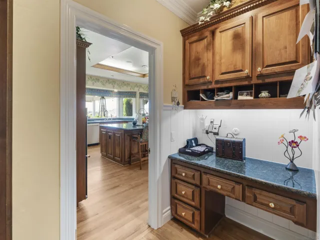 a view of a dining room with furniture and a potted plant