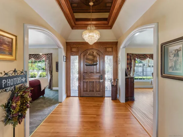 a living room with furniture and large windows
