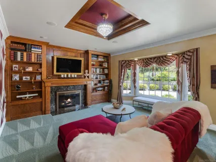 a bedroom with a bed and a flat screen tv with a bookshelf