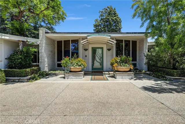 front view of house with chairs and a table in front of house