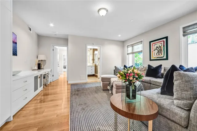 a living room with furniture potted plant and a window