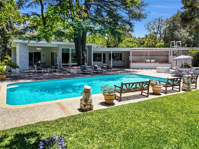 a view of a house with backyard porch and sitting area