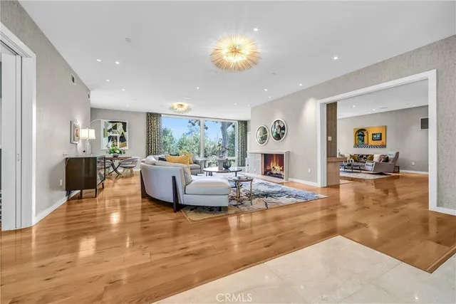 a living room with fireplace furniture and a wooden floor