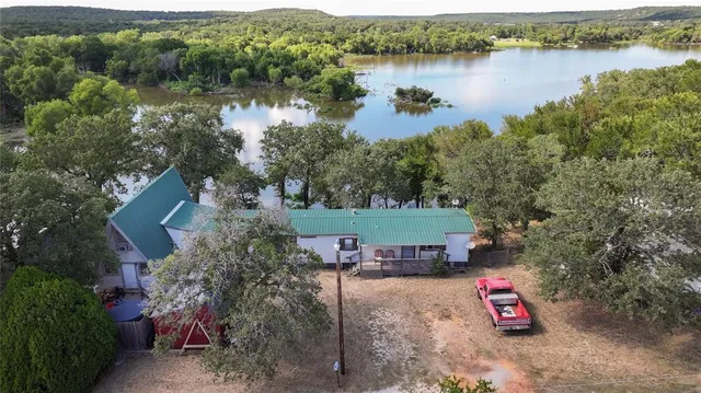 an aerial view of a house with a lake view
