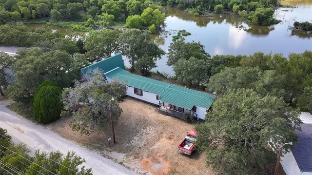 an aerial view of a house with a yard