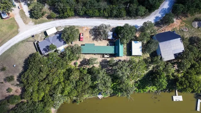 an aerial view of a house with a yard basket ball court and outdoor seating
