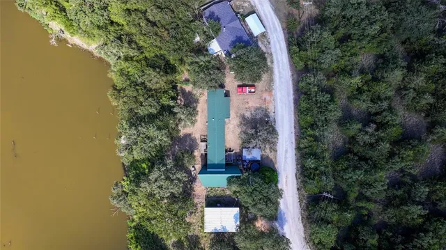 an aerial view of a house with swimming pool and garden space