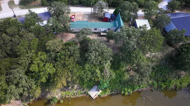 an aerial view of residential houses with outdoor space and street view