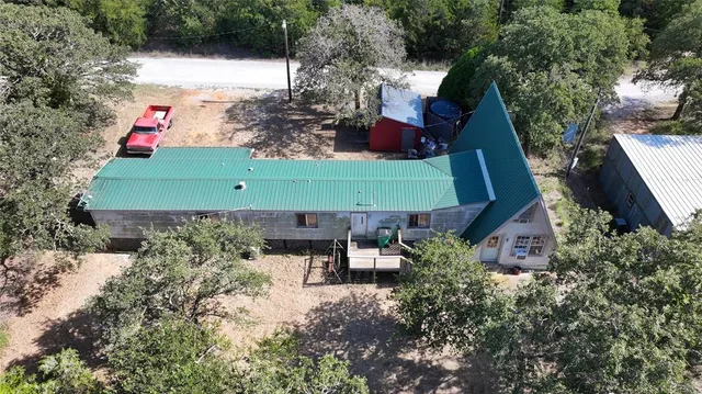 an aerial view of a house with yard swimming pool and outdoor seating