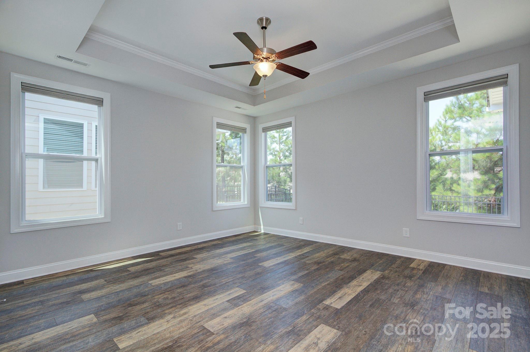 5527 Cheerful Lane Charlotte, NC 28215 - Photo 16 of 46 a view of an empty room with wooden floor and a window